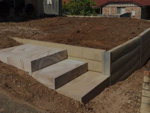 Concrete sleeper wall with Sandstone Steps Retain Terrain